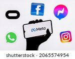 Small photo of Kazan, Russia - Oct 28, 2021: Facebook changes its name to Meta. Smartphone with Meta logo on the background on logos of products owned by facebook metaverse.