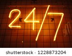 24 hrs 7 bar neon red signboard. Open sign. Day and night working. 24 hour concept.