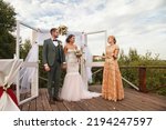 Registrar having official wedding ceremony next to Bridal couple. Bride and groom on wed irish style event in country outdoors. Marriage registration office and happiness married. Copy text space