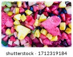 Delicious and decorative heart shaped festive bowl of fresh organic fruit salad with blueberries, watermelon, pineapple, red grapes, green grapes creating a festive feeling of health love celebration