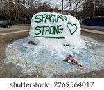 Small photo of February 20 2023 Ann Arbor Michigan USA MSU Shooting Memorial Spray Painted Rock Spartan Strong Honor Shooting Victims on University of Michigan Campus Fraternity Washtenaw Avenue and Hill Street