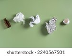 Glass bottle, plastic bag, crumpled paper, organic eggshell, foil on green studio background. Green strategy, sorting and segregation, zero waste sorting. Recycling production. Top view, copy space