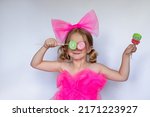 Small photo of Funny kid with candy marmalade, happy little girl eating big sugar marmalade, kid eating sweets,isolated on white background, studio
