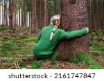 Woman Sitting In Forest And...