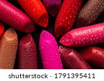 Closeup of lipsticks with water droplets