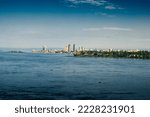 Small photo of shore of the city of Kinshasa with on its buildings under a blue sky