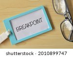 Eyeglasses and name tag written with BREAKPOINT