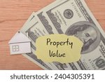 Small photo of money banknotes, property, and the prominently displayed words PROPERTY VALUE signifies the amalgamation of fiscal resources and the crucial valuation associated with real property investments