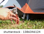 Young Woman Fastening Tent And...