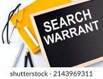 Small photo of SEARCH WARRANT text on a blackboard with notepad , pen, pencil