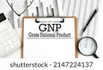 Small photo of Paper with GNP Gross National Product on a table with charts