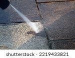 Small photo of Power cleaning dirty floor, paving slabs with high pressure water jet. Cleaning with high pressure water jet. Cleaning service washing backyard and pavers with pressure water.