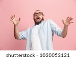 I'm afraid. Fright. Portrait of the scared man. Business man standing isolated on trendy pink studio background. Male half-length portrait. Human emotions, facial expression concept. Front view