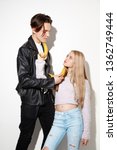 Small photo of Smash outright. Close up fashion portrait of two young cool hipster girl and boy wearing jeans wear. Studio shot of two models having fun and making serious faces.