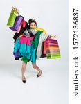 Small photo of Shopping like an issue. Woman addicted of sales. Overproduction and crazy demand. Female model wearing too much colorful clothes, need more. Fashion, style, black friday, sale, abusing purchases.