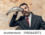 Small photo of Fish eye. Portrait of young male actor in the image of greatest painter Salvador Dali, artist isolated on light background. Retro style, comparison of eras, fashionable characters concept. Artwork