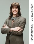 Small photo of Fashionista, dandy and dude. Portrait of young man in retro style, fashion of 70s, 80s years isolated on gray background. Concept of emotions, facial expression, sales. Male model in vintage outfits