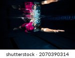 Small photo of Power and enrgy. One female swimmer in swimming cap and goggles training at pool. Underwater view of swimming movements details. Healthy lifestyle, power, energy, sports movement concept.