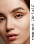 Small photo of Close-up portrait of young beautiful girl with shimmer eye shadow makeup. Well-kept healthy skin condition. Tenderness. Concept of natural beauty, skincare, cosmetology, cosmetics, health