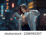 Beautiful young girl looking on tablet with smile and excitement. Online shopping, education, betting. Blurred city background. Modern technologies, youth, emotions, communication and business
