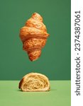 Small photo of Perfect. Crispy, fresh croissant, whole and cut in half isolated over green background. Concept of food, bakery, breakfast ideas, taste, freshness. Poser. Copy space for ad