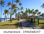 Small photo of Lauro de Freitas, Bahia, Brazil - 03 29 2021: The beach of Vilas do Atlantico is famous for promenade and sidewalk that is present all along the edge of the place. Tourists love cycling and surf