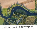 Small photo of Beautiful aerial view of a snaking stream, snaky river, twisty river, forest and agriculture fields