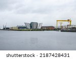 Small photo of Belfast, Northern Ireland - June 8 2022: Belfast cityscape with a view of a famous HW yellow crane and Titanic Museum