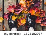 Casual lightweight leather shoes with colorful autumn fallen leaves on a wooden background. The concept of autumn season, autumn fashion, trendy lifestyle.
Autumn mood, background. Selective focus.
