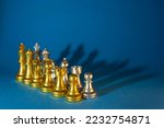 gold and silver chess pieces on a blue background.