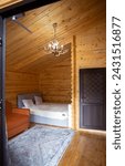 Small photo of The cabins interior is paneled with wood and furnished with a bed, sofa, and armoire. A bearskin rug adds a touch of warmth to the space.