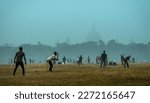 Small photo of Kolkata, India - January 15, 2023: Local boys playing an unorganized cricket match in a misty winter morning. Shallow depth of field.