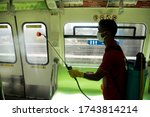 Small photo of MUMBAI/INDIA - MAY 28, 2020: A worker sprays disinfectant to sanities a monorail as a preventive measure against the COVID-19 corona virus. MMRDA is preparing to resume its services.