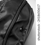 Small photo of clip closure and zipper closure on the black backpack