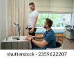 Man undergoing body composition analysis supervised by healthcare professional