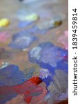 Small photo of Photo of a painter palette with mixed and unmixed acrylic colours