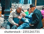Small photo of Potosi city, Bolivia; February 10 2014: Conversation of three old men seated in the bench of the main city square. Daily chatter