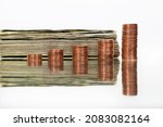 A stack of dollar bills and copper coins