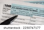 Small photo of A close up of upper left corner of IRS form 1040 with focus on filing status options.