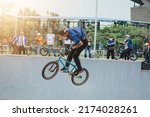 Small photo of Palembang, Indonesia 1 July 2022 - A young rider on a BMX bike starts the attraction. BMX freestyle in a skate park.