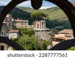 Small photo of Tivoli, Italy - 04 11 2023: the temple of the Sibyl of Tivoli seen from a panoramic point through a metal railing