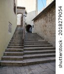 Small photo of Omis, Croatia - July 23, 2021: Stairs in the old town of Omis leading to the Mirabela fortress. Croatian historic street.