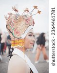 Small photo of Banyuwangi, Indonesia - September 21 2023 : Portrait from the side of a smiling infatuated dancers. Selective focus