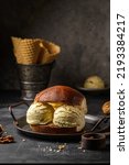 Small photo of brioche with ice cream on a dark background. High quality photo