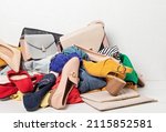 Small photo of Fast fashion background with pile of cheap, low quality clothes. Garment made in unjust, inhumane conditions idea. Environmental impact, carbon emissions concept