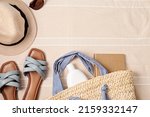 Small photo of Summer vacations flat lay with beach accessories. Slippers, sunscreen, seashells over beach towel background Travel, tourism concept. Top view