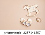 Small photo of Gender neutral baby shoes, rocking horse and teether. Organic newborn fashion, branding, small business idea