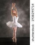 Young woman ballerina in white...