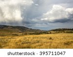 Dark storm clouds over golden grasses of the Lamar Valley in Yellowstone National Park, Wyoming.