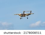 Small photo of Leszno, Poland - June, 17, 2022: Antidotum Airshow Leszno, North American Rockwell OV-10 Bronco, light attack and observation aircraft. The plane lands with the landing gear extended.